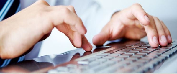 students typing on keyboard